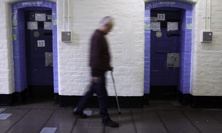 Man with a walking stick in Wandsworth Prison. Photo by Andrew Aitchison